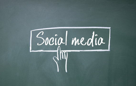 finger click social media symbol on blackboard