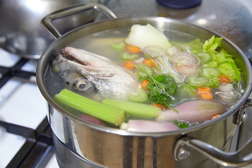 Cooking  fish broth with vegetables