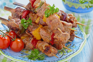 Grilled pork meat and vegetable kebabs
