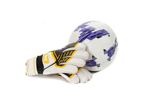 Soccer goalkeeper gloves and a ball on white