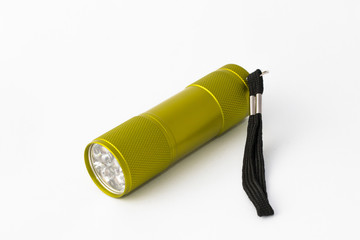 Yellow-green led aluminum flashlight on a white background