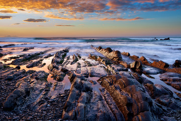 Flysch in Barrika beach at sunset. Basque country, Spain