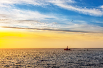 Fototapeta na wymiar Lone tugboat at sea in the morning.