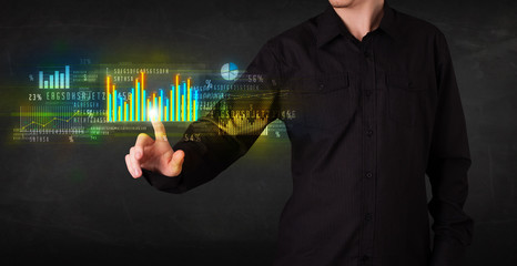 Young business person touching colorful charts and diagrams