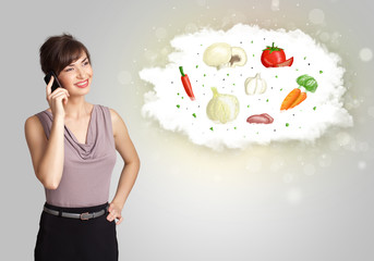 Pretty woman presenting a cloud of healthy nutritional vegetable