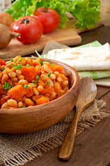 Stewed white beans and sliced pumpkin in tomato sauce