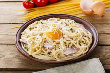 pasta carbonara on a plate with egg yolk and parmesan cheese