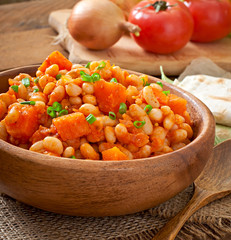 Stewed white beans and sliced pumpkin in tomato sauce