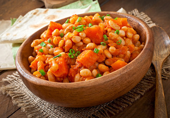 Stewed white beans and sliced pumpkin in tomato sauce