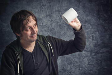 Disappointed Man Looking at Empty Cup