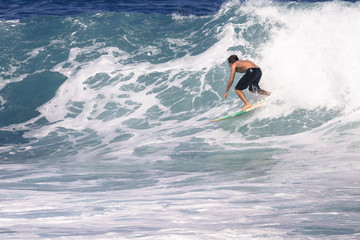 Extreme surfer riding giant ocean wave in Hawaii