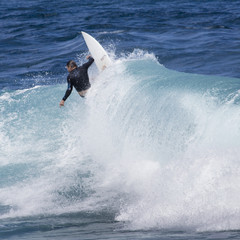 Extreme surfer riding giant ocean wave in Hawaii