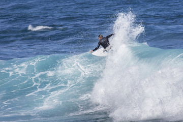 Extreme surfer riding giant ocean wave in Hawaii