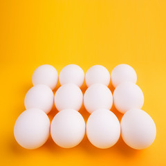 White eggs on a yellow background