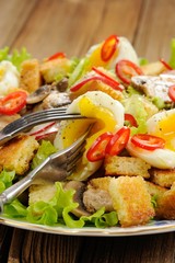 Salad Caesar with mushrooms, eggs, chili and radish with two for