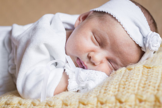 Close-up portrait of newborn baby girl sleeping