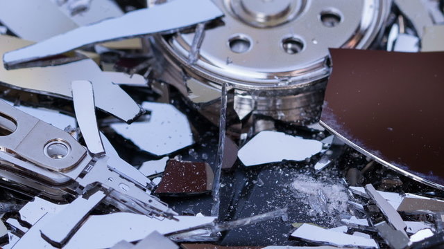 Macro shot of the destruction of hard drive using a screwdriver
