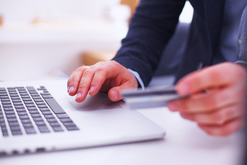 Fototapeta premium Businessman using his credit card for an online transaction