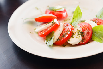 Tomato and mozzarella with basil leaves