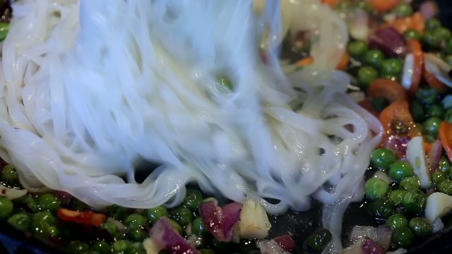 rice noodles, green peas and carrots, red sauce, garlic and onio