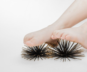 massage therapy on feet with artificial sea urchins model