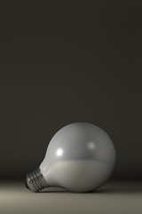 Globe white glossy light bulb lying on gray squared background