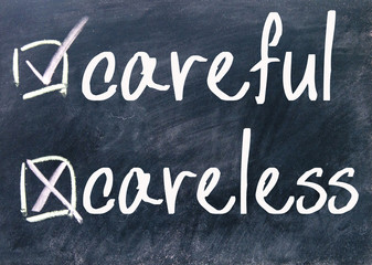 Fototapeta premium careful and careless sign on blackboard
