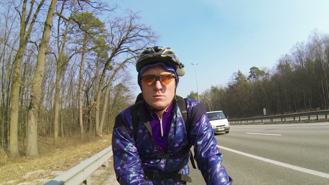 adult man  cyclist on  city highway. POV clip  face view
