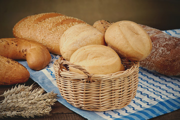 Wicker basket with bread products on the tablecloth