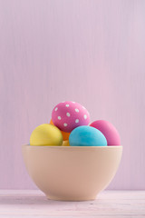 Easter eggs on light painted background vertical