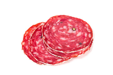 Slices of salami sausage on a white background