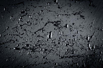 water on dark stone surface
