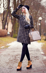 Fashion young woman with bag outdoors