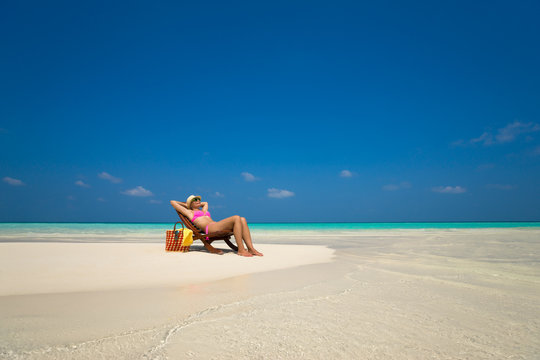 Beach vacation. Hot beautiful woman enjoying looking view of bea