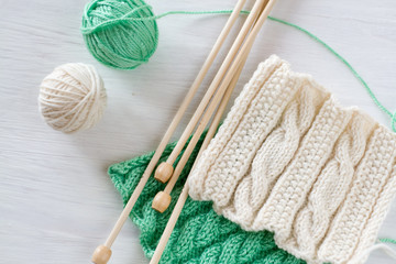 Two bright patterns, yarn balls and needles for knitting