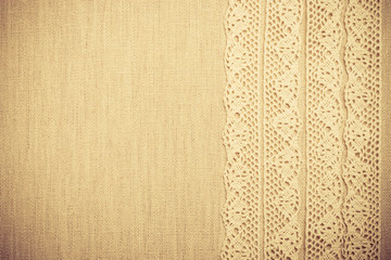 Fototapeta premium Lace ribbon on linen cloth background