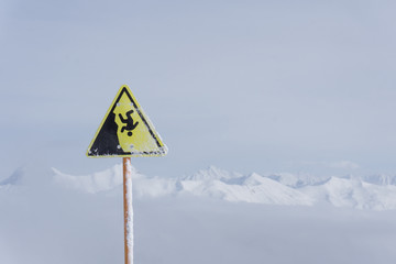 danger steep cliff mountain sign