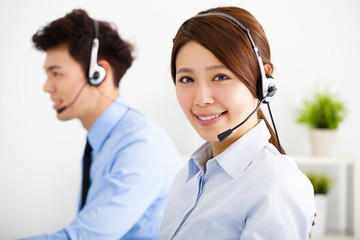 businesswoman and businessman with headset working in office
