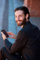 Businessman smiling with cell phone