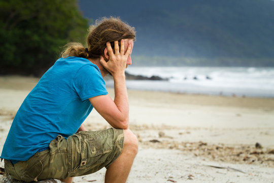 Depressed man at the beach