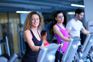 Group of people running on treadmills