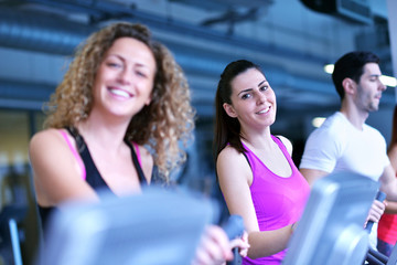 Group of people running on treadmills