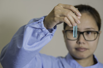 Young Asian lab worker reading a chemical test