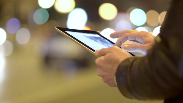 Man Using Touchpad in the night city