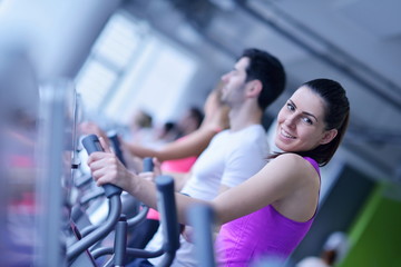 Group of people running on treadmills