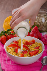 Healthy breakfast cornflakes with milk and fruits