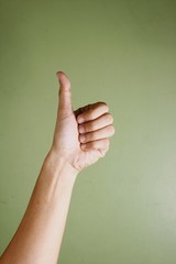 Hand making a thumbs up sign