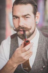 handsome big moustache hipster man smoking pipe