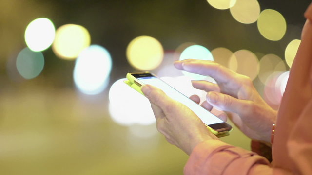Woman using smart- phone in the night city