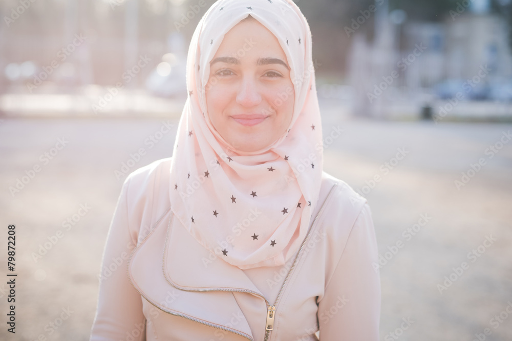 Wall mural young beautiful muslim woman at the park